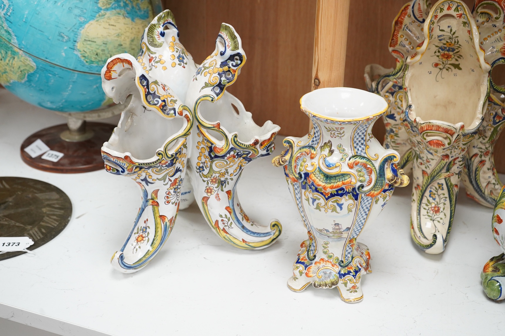 Two late 19th / early 29th century French faience vases and two similar centrepieces, largest 35cm high